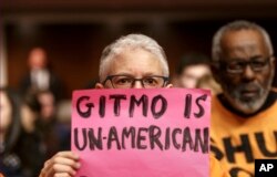 FILE - Ellen Sturtz, an activist from the antiwar group CodePink, participates in a silent protest during the Senate Armed Services Committee hearing in Washington on the detention center in Guantanamo, Cuba, Thursday, Feb. 5, 2015.