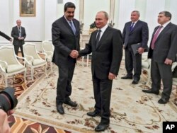 Russian President Vladimir Putin, center right, greets Venezuela's President Nicolas Maduro during their meeting at the Kremlin in Moscow, Russia, Oct. 4, 2017.