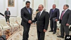 Russian President Vladimir Putin, center right, greets Venezuela's President Nicolas Maduro during their meeting at the Kremlin in Moscow, Russia, Oct. 4, 2017.