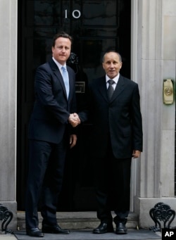 Britain's Prime Minister David Cameron (L) meets Mustapha Abdel Jalil, President of the Libyan Transitional Council, at Downing Street in London, May 2011.
