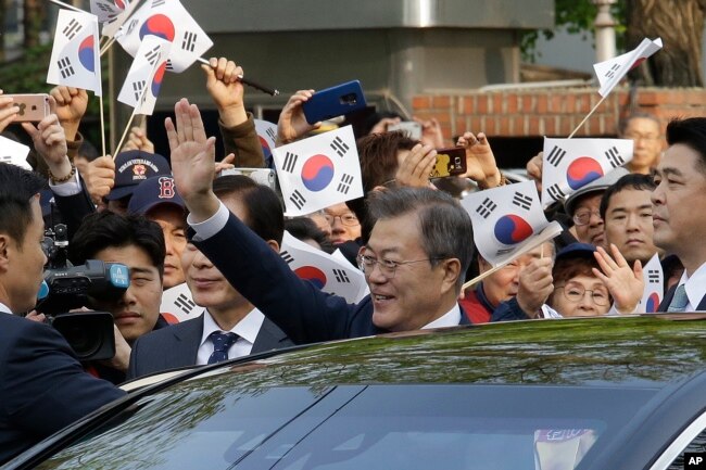 Tổng thống Hàn Quốc Moon Jae-in vẫy chào người dân tụ tập gần Dinh Ngói Xanh (phủ tổng thống) trước khi lên đường đến dự hội nghị thượng đỉnh liên Triều, Seoul, Hàn Quốc, ngày 27 tháng 4, 2018.