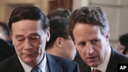 US Treasury Secretary Timothy Geithner (r) and Chinese Vice Premier Wang Qishan, attend a meeting with US and Chinese CEO's at the Blair House in Washington, Tuesday, May 10, 2011.