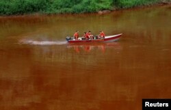 Members of a rescue team use a boat on the Paraopeba River as they search for victims of a collapsed tailings dam owned by Brazilian mining company Vale SA, in Brumadinho, Brazil, Feb. 4, 2019.
