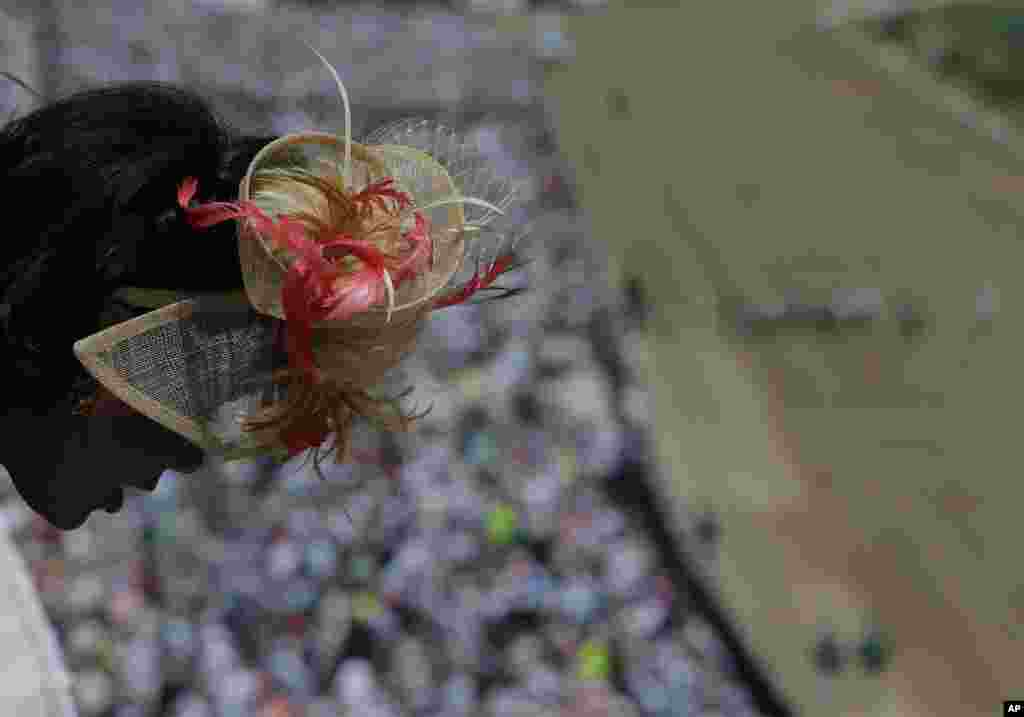 A woman looks out over a balcony before the 140th running of the Kentucky Derby horse race at Churchill Downs in Louisville, Kentucky, May 3, 2014.