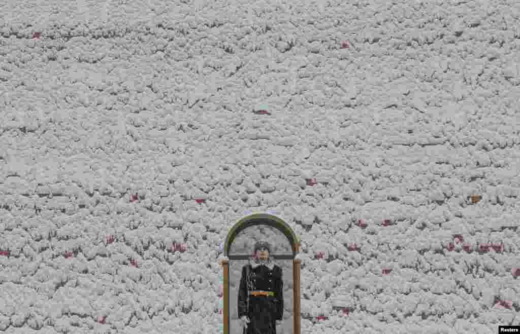 A honor guard stands at the Tomb of the Unknown Soldier by the Kremlin wall in Moscow, Russia.