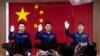 Astronot China, dari kiri: Tang Hongbo, Nie Haisheng, dan Liu Boming melambaikan tangan mereka pada konferensi pers di Pusat Peluncuran Satelit Jiuquan menjelang peluncuran Shenzhou-12 dari Jiuquan, barat laut China, Rabu, 16 Juni 2021. (AP Photo/Ng Han Guan)