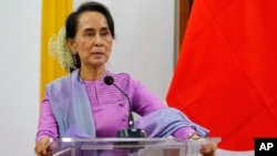 FILE - Myanmar's State Counselor and Foreign Minister Aung San Suu Kyi speaks during a press conference in Naypyitaw, Jan. 12, 2018.