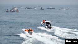 FILE - Iranian boats take part in naval war games in the Persian Gulf and the Strait of Hormuz, off southern Iran, April 22, 2010.