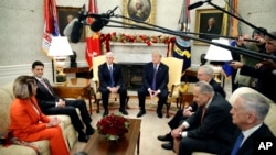 FILE - President Donald Trump, accompanied by Vice President Mike Pence, meets with congressional leaders including House Minority Leader Nancy Pelosi of Calif., left, House Speaker Paul Ryan of Wis., Senate Majority Leader Mitch McConnell of Ky., Senate Minority Leader Chuck Schumer of N.Y., and Defense Secretary Jim Mattis in the Oval Office of the White House, Dec. 7, 2017. 