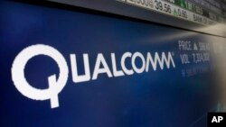 FILE - The logo for Qualcomm appears on a screen at the Nasdaq MarketSite, in New York