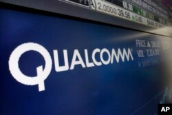 FILE - The logo for Qualcomm appears on a screen at the Nasdaq MarketSite, in New York