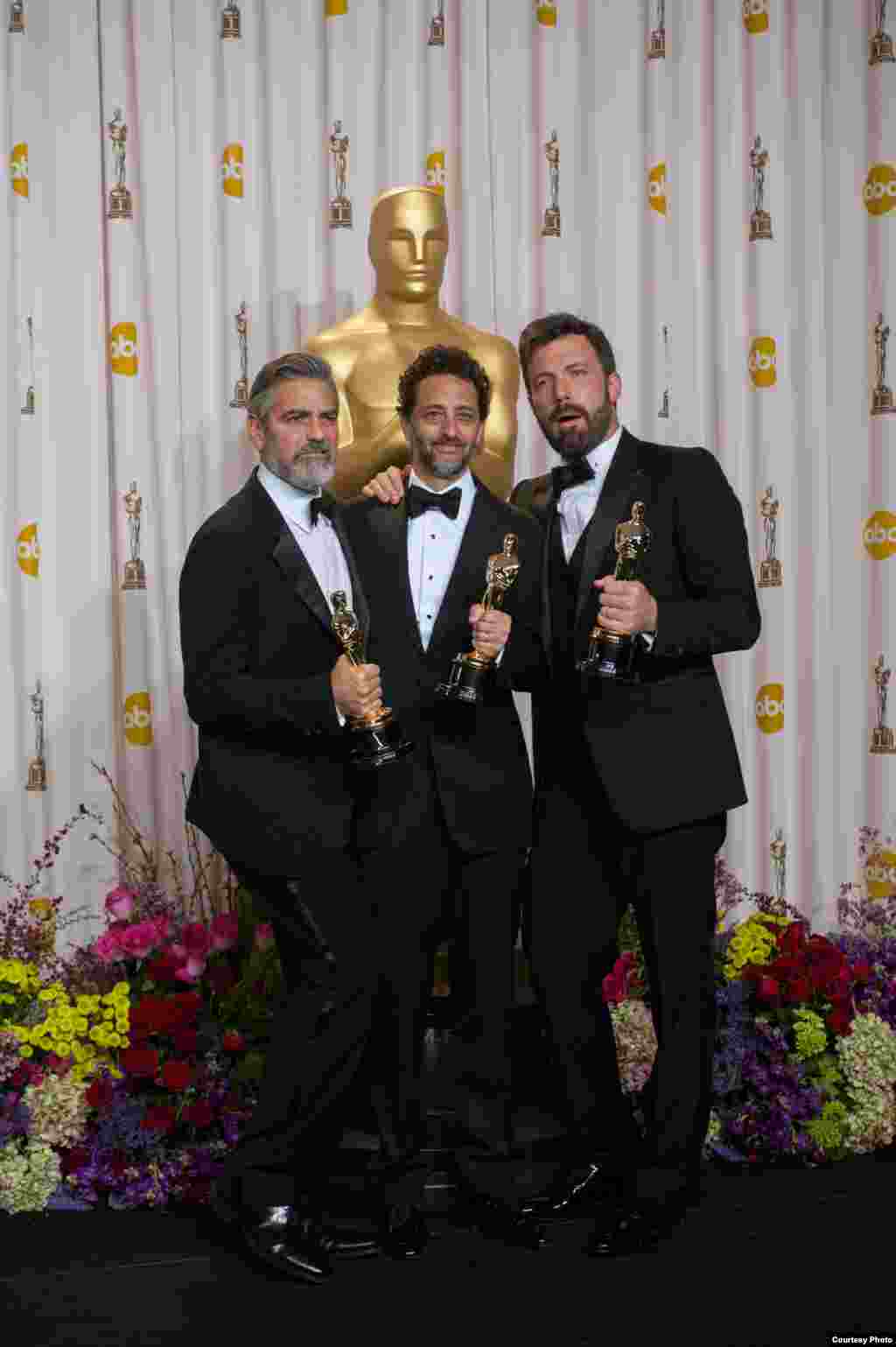 Producers George Clooney, Grant Heslov and Ben Affleck pose for the press after winning the Oscar® for best motion picture of the year for “Argo”, Feb. 24, 2013. (Photo: AMPAS)