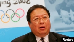 FILE - Hong Kong's Secretary for Home Affairs Patrick Ho speaks during a news conference, announcing that the equestrian events at the 2008 Beijing Olympics would be staged in Hong Kong, July 8, 2005, .