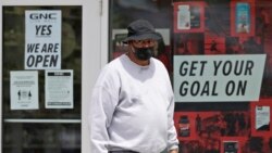 A man walks out of a GNC store, Thursday, May 21, 2020, in University Heights, Ohio.