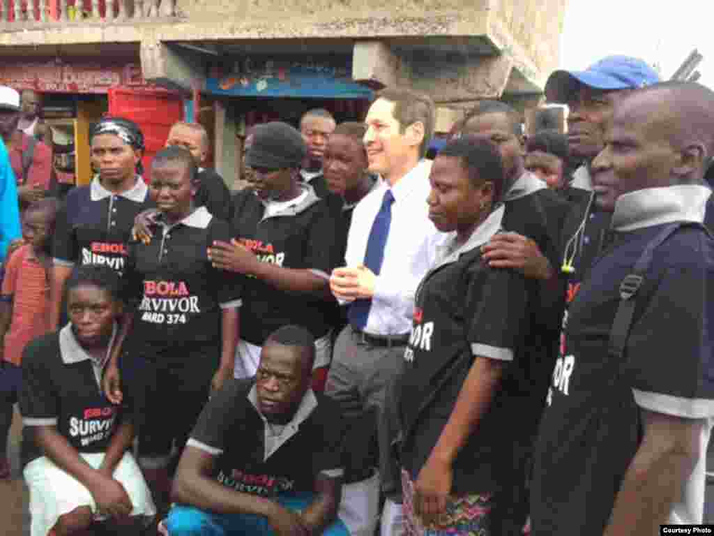 CDC Director Dr. Tom Frieden poses for a group picture with Ebola survivors in Magazine Wharf, Sierra Leone. (Courtesy - U.S. Centers for Disease Control)