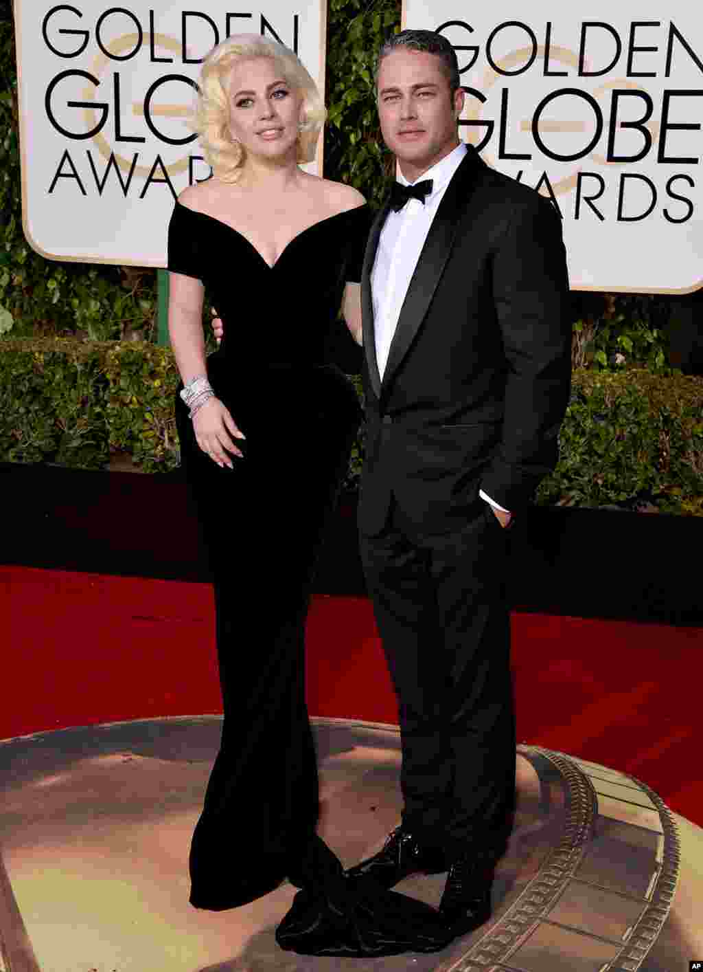 Lady Gaga, left, and Taylor Kinney arrive at the 73rd annual Golden Globe Awards on Jan. 10, 2016, at the Beverly Hilton Hotel in Beverly Hills, Calif.