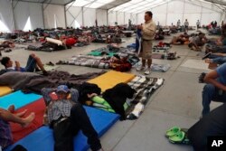 Central American migrants settle in a shelter at the Jesus Martinez stadium in Mexico City, in Mexico City, Jan. 28, 2019.