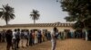 Senegalese voters line up to cast their votes at a polling station in Dakar, Senegal, Sunday Feb. 24, 2019. Voters are choosing whether to give President Macky Sall a second term in office as he faces four challengers. 