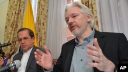 Ecuador's Foreign Minister Ricardo Patino (L) and WikiLeaks founder Julian Assange speak during a press conference inside the Ecuadorian Embassy in London, where he confirmed he "will be leaving the embassy soon", Monday Aug. 18, 2014.