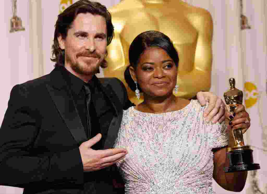 Octavia Spencer with presenter Christian Bale and her award for best supporting actress in "The Help." (AP)