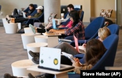Students look out over the campus as they work on computers at the renovated James Branch Cabell library on the campus of Virginia Commonwealth University in Richmond, Va., Thursday, April 28, 2016.