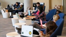 Students look out over the campus as they work on computers at the renovated James Branch Cabell library on the campus of Virginia Commonwealth University in Richmond, Va., Thursday, April 28, 2016.