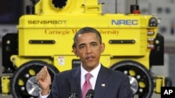 With a robotic vehicle behind him, President Barrack Obama makes remarks during a visit to Carnegie Mellon University's National Robotics Engineering Center in Pittsburgh, Friday, June 24, 2011