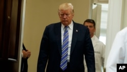 President Donald Trump arrives in the Roosevelt Room of the White House in Washington for a Veterans Affairs Department "telehealth" event, Aug. 3, 2017.