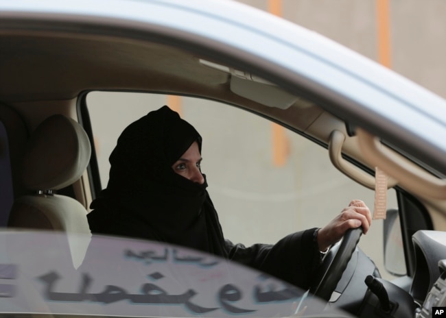 FILE - Aziza Yousef drives a car on a highway in Riyadh, Saudi Arabia, March 29, 2014, as part of a campaign to defy Saudi Arabia's ban on women driving.