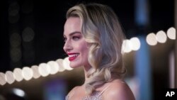 FILE - Actress Margot Robbie poses for photographers upon arrival at the premiere of the film 'Mary Queen of Scots,' in London, Dec. 10, 2018.