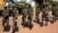 FILE - Soldiers from the presidential guard patrol outside the Radisson Blu hotel in Bamako, Mali, Nov. 21, 2015.