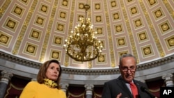 Senate Minority Leader Sen. Chuck Schumer of N.Y., right, speaks as he stands next to House Speaker Nancy Pelosi of Calif., left, on Capitol Hill in Washington, Aug. 3, 2020. 