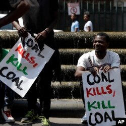 FILE - Climate protesters hold placards during their demonstration outside the local government legislature's offices in Johannesburg, South Africa, Friday, Sept. 20, 2019