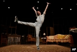 Grayson Hart jumps for a portrait at the Ned R. McWherter West Tennessee Cultural Arts Center in Jackson, Tenn. He is one of thousands of young adults who graduated high school during the pandemic and are taking career routes other than college. (AP Photo/Mark Zaleski)