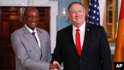 Secretary of State Mike Pompeo, right, shakes hands with Guinean President Alpha Conde at the State Department in Washington, Sept. 13, 2019.