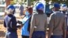 FILE - Police arrest a health worker during a protest against economic hardship and poor working conditions during the coronavirus disease (COVID-19) outbreak in Harare, Zimbabwe, July 6, 2020.