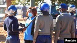 FILE - Police arrest a health worker during a protest against economic hardship and poor working conditions during the coronavirus disease (COVID-19) outbreak in Harare, Zimbabwe, July 6, 2020.