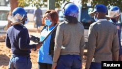 FILE - Police arrest a health worker during a protest against economic hardship and poor working conditions during the coronavirus disease (COVID-19) outbreak in Harare, Zimbabwe, July 6, 2020.