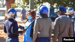 FILE - Police arrest a health worker during a protest against economic hardship and poor working conditions during the coronavirus disease (COVID-19) outbreak in Harare, Zimbabwe, July 6, 2020.