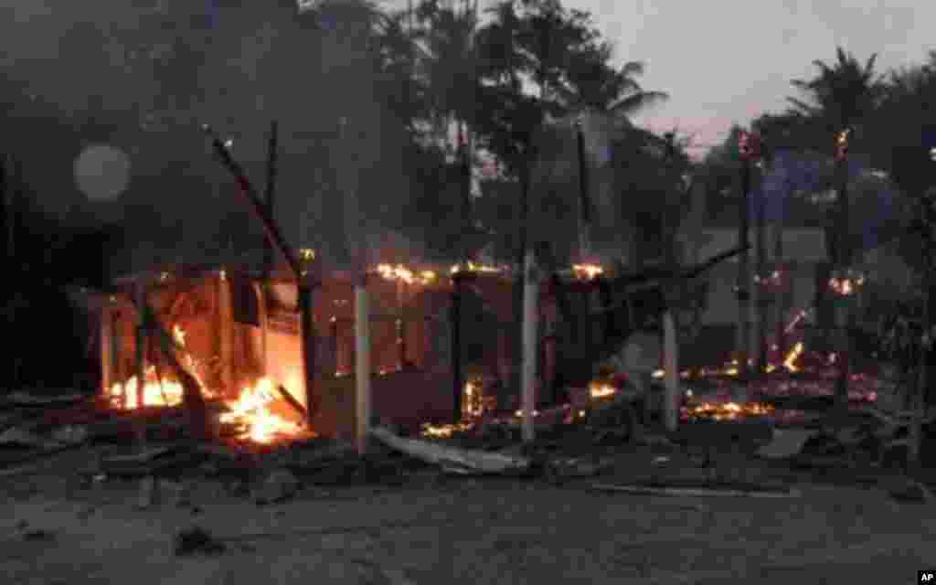 A house burns in a Thai village near a 11th-century Preah Vihear temple at the border between Thailand and Cambodia February 4, 2011. Thai and Cambodian soldiers exchanged fire in a two-hour border clash on Friday that killed two Cambodian soldiers and a 