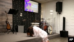 Janett Laguna prays prior to services at Casa de Adoracion, Oct. 27, 2024, in Phoenix.