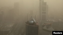 FILE - A general view shows the skyline of Beijing, China, shrouded in smog, March 15, 2021. 