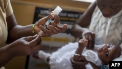 A baby receives Malaria vaccine Mosquirix by a nurse at the maternity ward of the Ewin Polyclinic in Cape Coast, Ghana, April 30, 2019. 