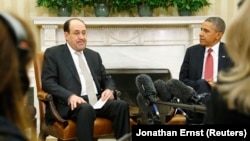 Iraqi Prime Minister Nuri al-Maliki (L) and U.S. President Barack Obama (R) pause for translation as they talk to reporters in the Oval Office after meeting at the White House in Washington, November 1, 2013. 