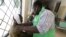 A paramedic at the Malindi district hospital attends to a policeman injured when rival communities clashed in Tana River district in the Tana Delta region, Kenya, Jan. 9, 2013. 