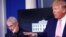 Dr. Anthony Fauci, director of the National Institute of Allergy and Infectious Diseases, listens as President Donald Trump speaks at the daily coronavirus response briefing at the White House in Washington, April 1, 2020.