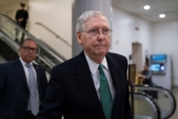 FILE - Senate Majority Leader Mitch McConnell, R-Ky., heads to a briefing Jan. 8, 2020, on Capitol Hill in Washington.
