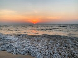 FILE - Sun sets at the candolim beach on the Arabian Sea coast in Goa, India, Dec.6, 2020.