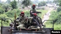 Ivory Coast Republican forces patrol near Sacre village, in the western Tai area near Ivory Coast's border with Liberia, June 17, 2012.