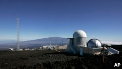 FILE - This Oct. 25, 2009, photo shows the Mauna Loa Observatory atmospheric research facility on the island of Hawaii. The volcano of Mauna Kea is seen in the background.